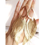 Satin gold extra long leather feather earrings.