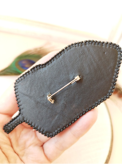 Black feather embroidery brooch.