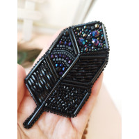Black feather embroidery brooch.