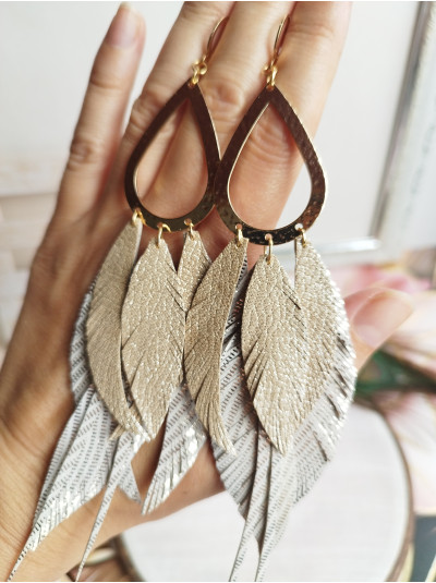beige antique gold extra long leather feather earrings.